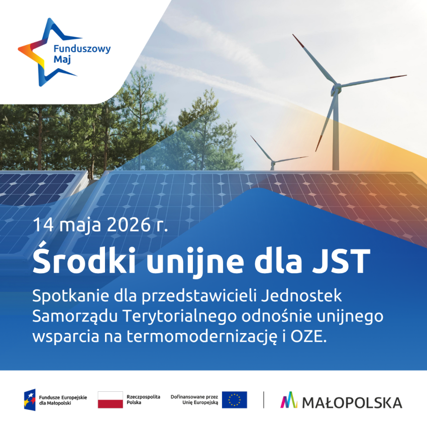 Panele słoneczne, w tle wiatraki.