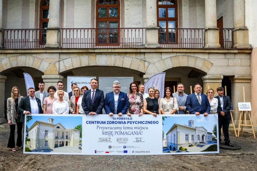 Uczestnicy wydarzenia z banerem : Tu powstaje Centrum Zdrowia Psychicznego. Przywracamy temu miejscu Misję Pomagania!