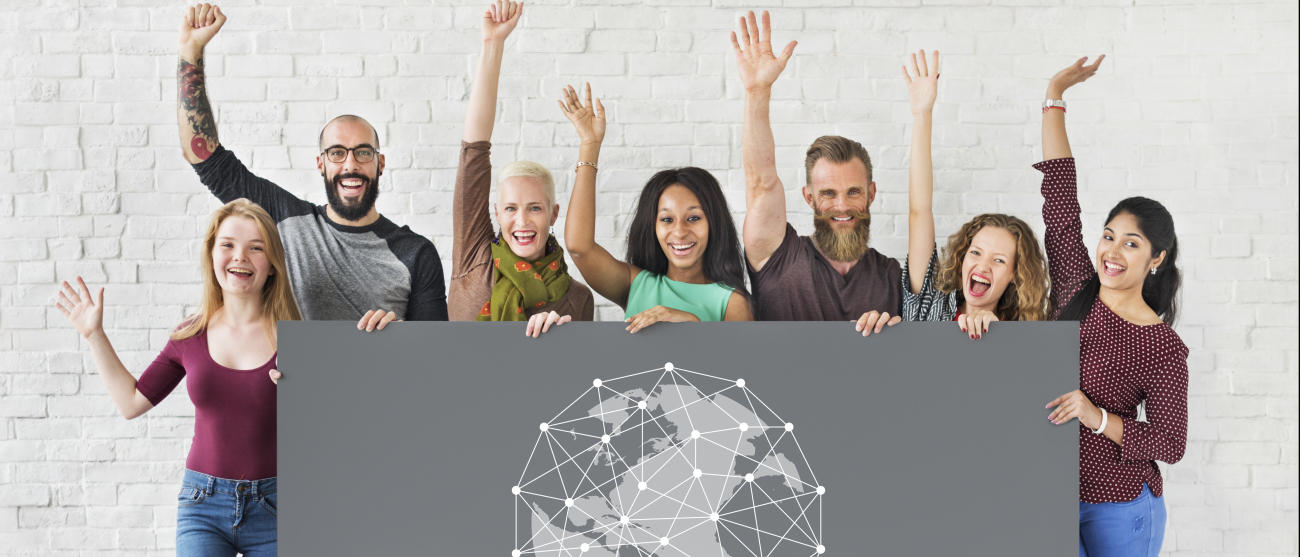 Młodzi ludzie trzymający baner z nakładką sieci na kuli ziemskiej.